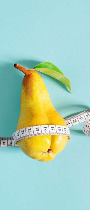 Weight loss concept, yellow pear checks body shapes with measuring tape, blue background